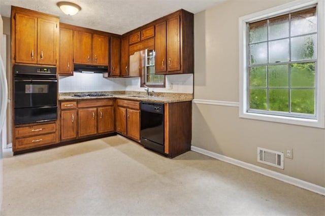 1513 Dupree Rd, Woodstock, GA 30189 - kitchen featuring black appliances, a warming drawer, brown cabinets, under cabinet range hood, and decorative backsplash
