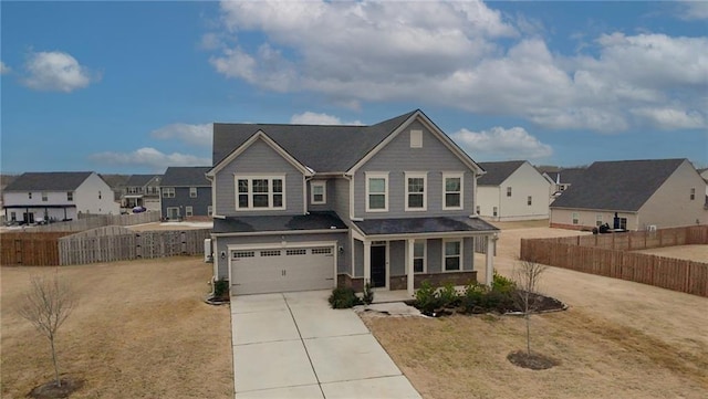 view of front of property with a front yard, a garage, and a porch