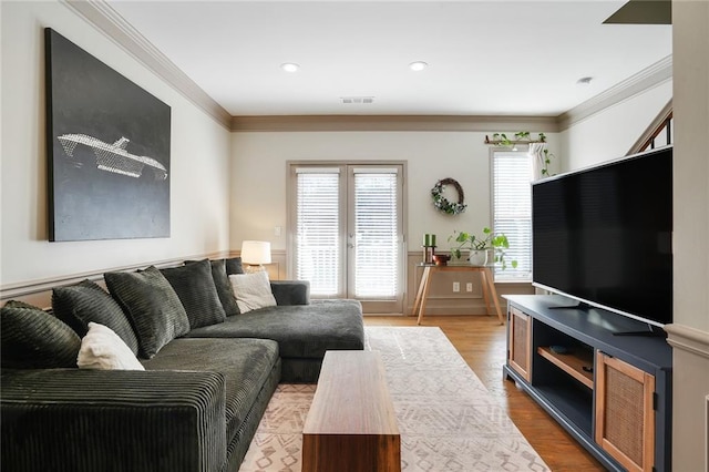 living room featuring recessed lighting, wood finished floors, visible vents, french doors, and ornamental molding