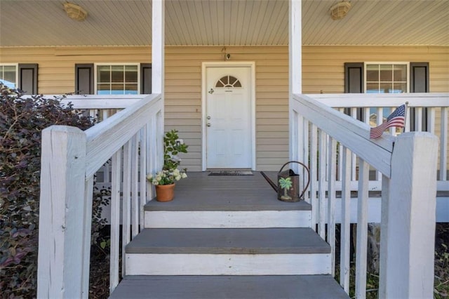 view of exterior entry featuring covered porch