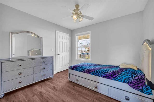 bedroom with ceiling fan and dark hardwood / wood-style floors