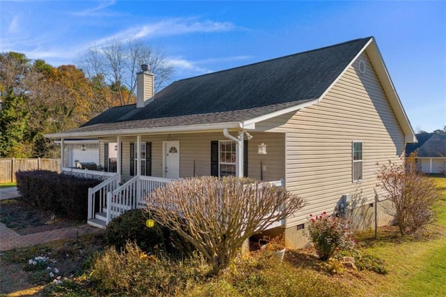 view of front of home featuring covered porch, a shingled roof, crawl space, and a chimney