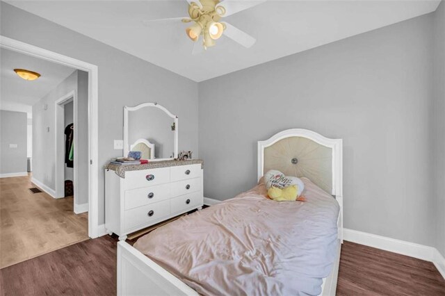 bedroom with ceiling fan and dark hardwood / wood-style flooring