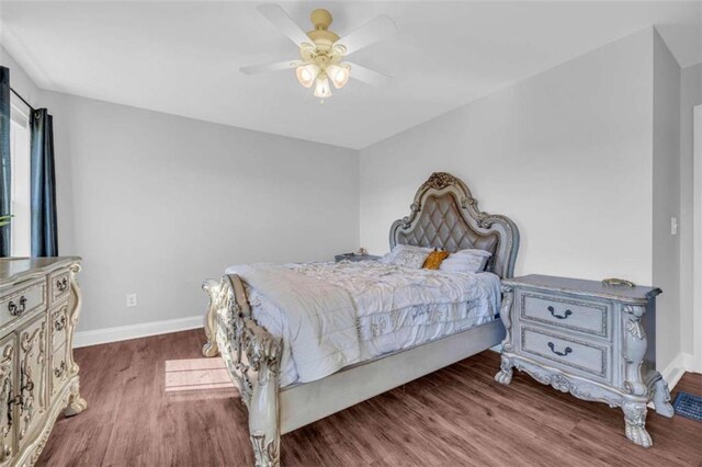 bedroom with dark wood-type flooring and ceiling fan