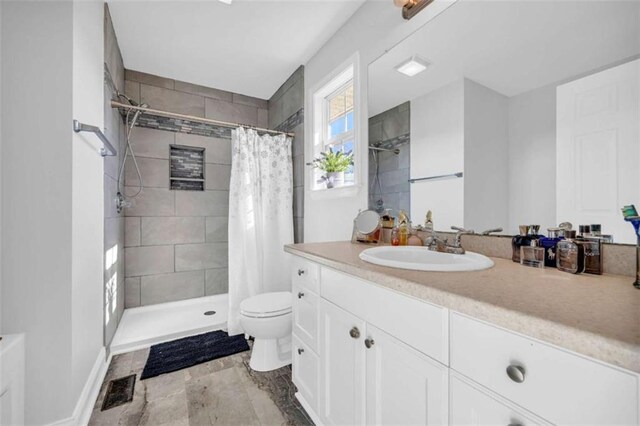 bathroom featuring vanity, toilet, and walk in shower