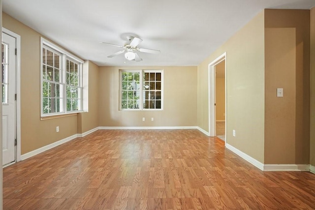 empty room featuring ceiling fan and light hardwood / wood-style flooring