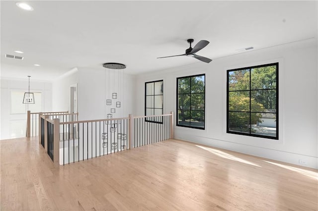 unfurnished room with light hardwood / wood-style flooring and ceiling fan