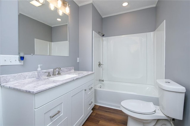 full bathroom with toilet, wood-type flooring, ornamental molding, vanity, and shower / bath combination