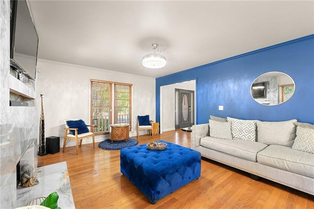 living room with ornamental molding and hardwood / wood-style floors