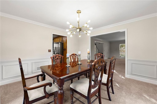 dining room with ornamental molding, carpet flooring, and a notable chandelier