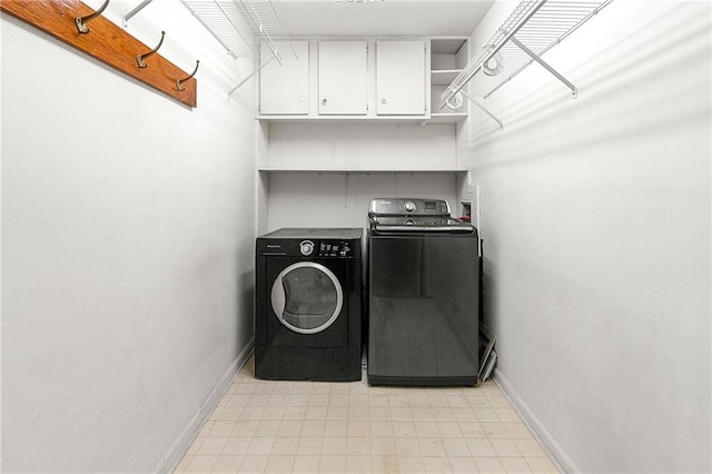 washroom featuring independent washer and dryer and cabinets