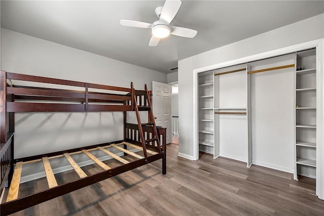 bedroom featuring hardwood / wood-style flooring, ceiling fan, and a closet