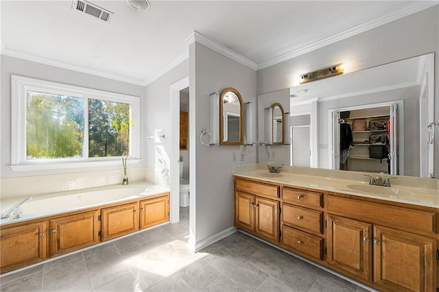 bathroom with a tub to relax in, ornamental molding, toilet, and vanity