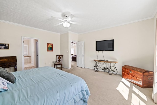 bedroom featuring carpet floors, crown molding, ensuite bath, and a ceiling fan