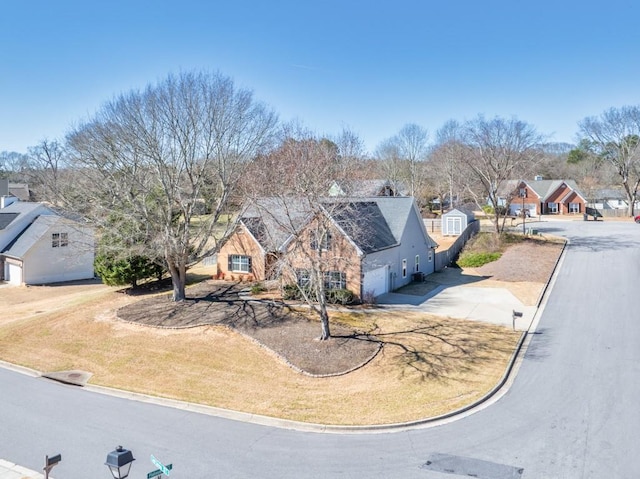 view of front of home featuring driveway, a garage, stone siding, a residential view, and a front lawn