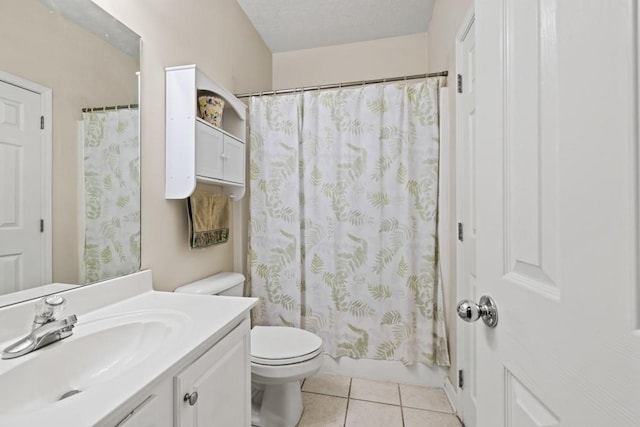 bathroom with tile patterned flooring, vanity, and toilet