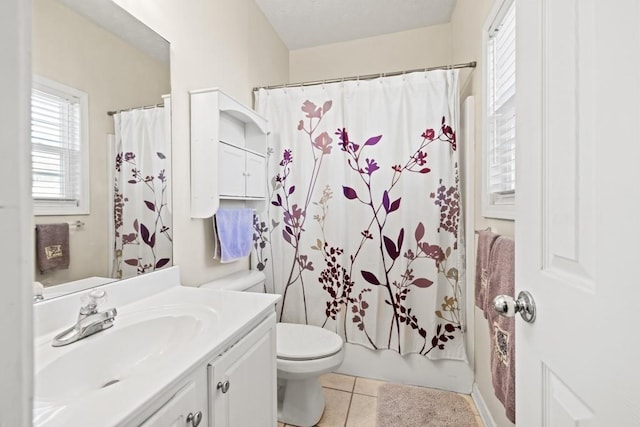 bathroom featuring toilet, tile patterned flooring, shower / bath combination with curtain, and vanity