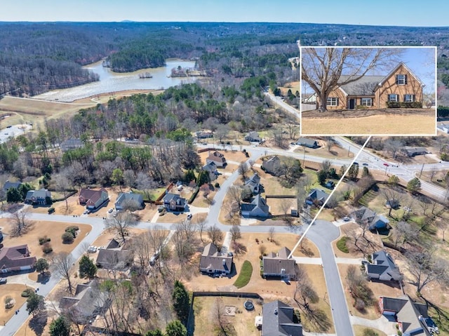 bird's eye view featuring a water view and a wooded view