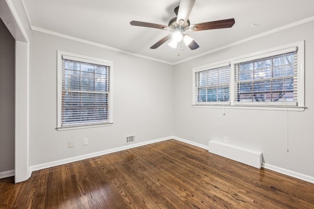 empty room with ornamental molding, dark wood-type flooring, and ceiling fan