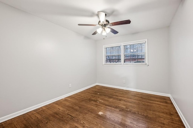 empty room featuring dark wood-type flooring and ceiling fan