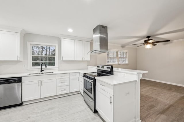 kitchen with sink, appliances with stainless steel finishes, white cabinets, island exhaust hood, and kitchen peninsula