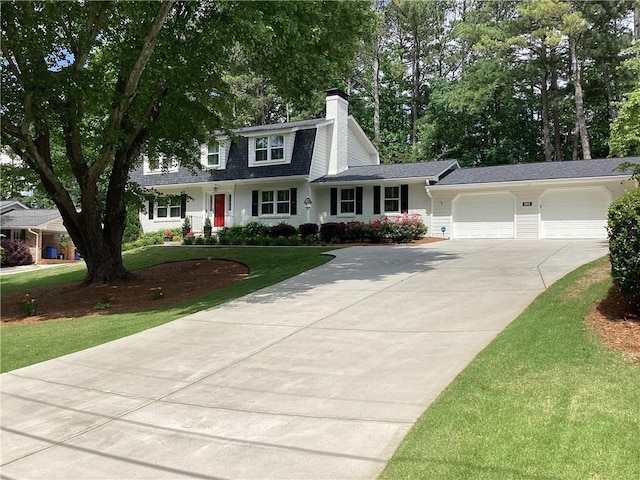 2917 Townley Cir, Atlanta, GA 30340 - view of front of home featuring a chimney, an attached garage, driveway, a front lawn, and roof with shingles