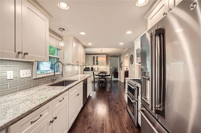 2917 Townley Cir, Atlanta, GA 30340 - kitchen with stainless steel appliances, a sink, white cabinets, recessed lighting, and hanging light fixtures