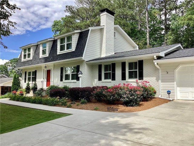 2917 Townley Cir, Atlanta, GA 30340 - view of front of house featuring a garage, brick siding, concrete driveway, a gambrel roof, and a shingled roof