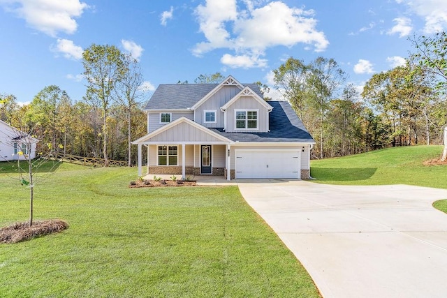 craftsman inspired home with covered porch, a front yard, and a garage