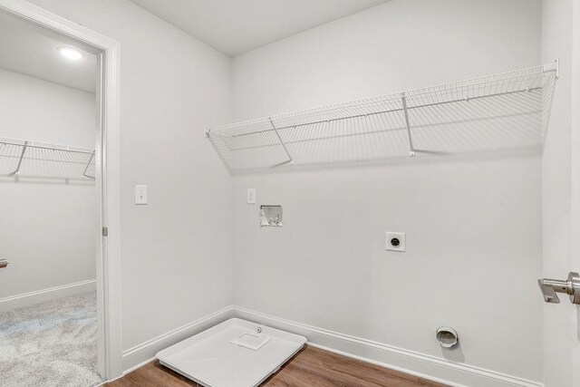 clothes washing area with hookup for an electric dryer, hardwood / wood-style flooring, and hookup for a washing machine