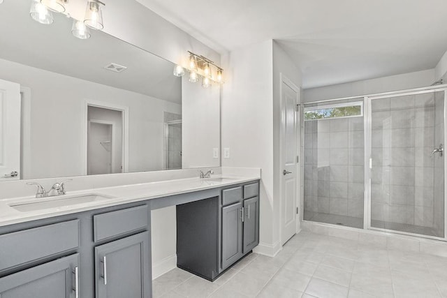 bathroom with tile patterned flooring, vanity, and an enclosed shower