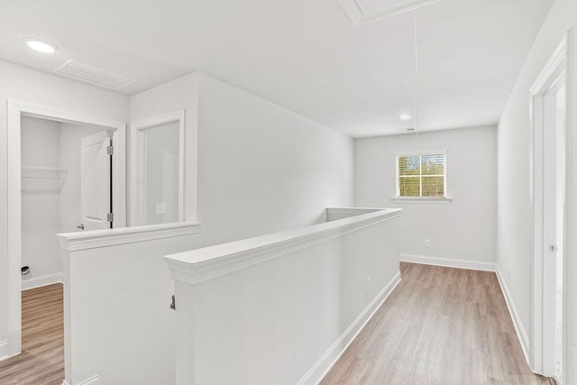 corridor with light hardwood / wood-style floors