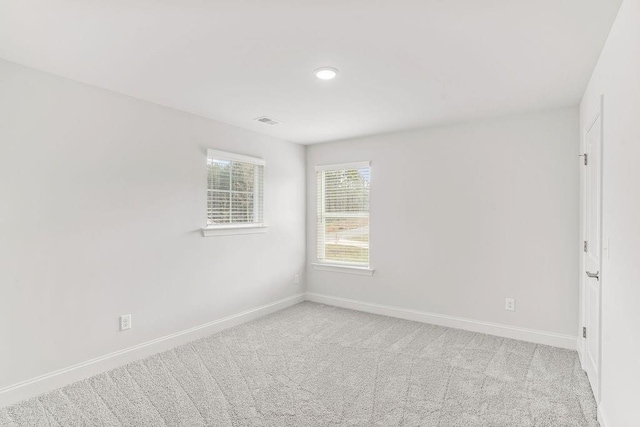 spare room with light carpet