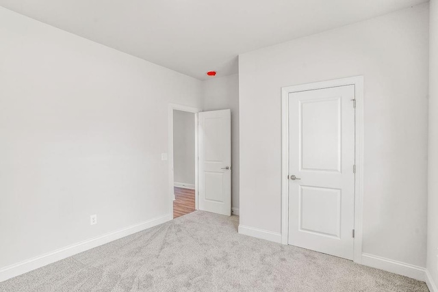 unfurnished bedroom with light colored carpet