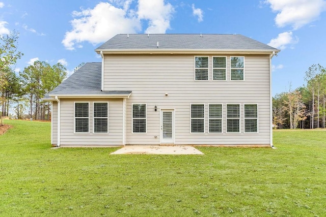 back of property featuring a lawn and a patio