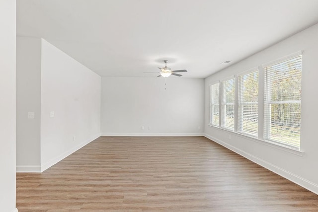 unfurnished room with ceiling fan and light hardwood / wood-style floors