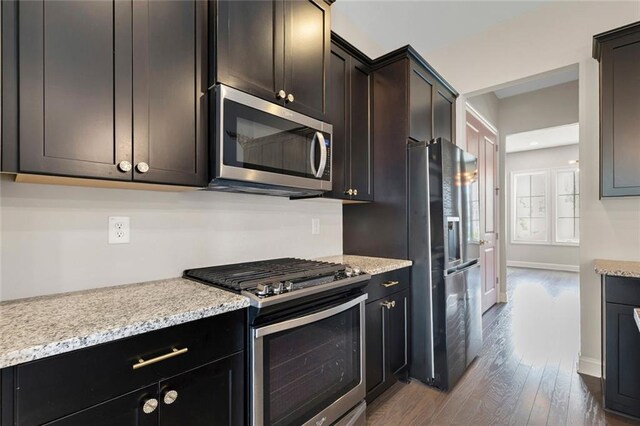 1954 Summit Trace Cir NW, Atlanta, GA 30318 - kitchen featuring appliances with stainless steel finishes, wood finished floors, light stone countertops, and dark brown cabinetry