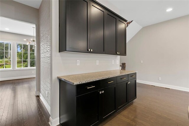 1954 Summit Trace Cir NW, Atlanta, GA 30318 - kitchen with dark wood-style flooring, a chandelier, recessed lighting, light stone countertops, and dark cabinetry