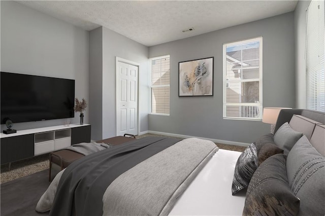 unfurnished room featuring carpet flooring and a textured ceiling