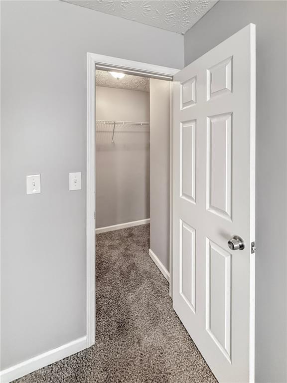 bedroom with carpet flooring, a textured ceiling, and ceiling fan