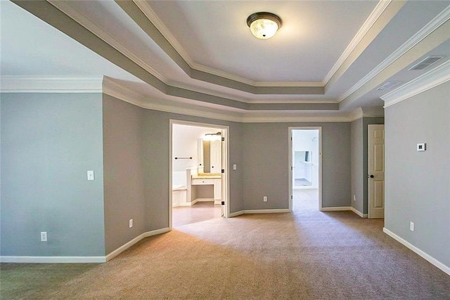 unfurnished bedroom featuring a raised ceiling, ensuite bath, carpet, crown molding, and baseboards