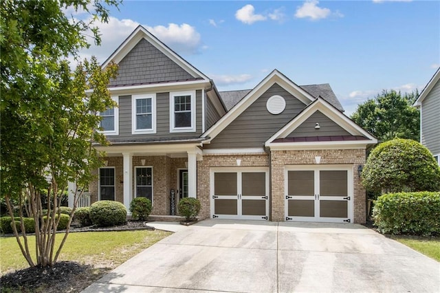 7927 Keepsake Ln, Flowery Branch, GA 30542 - craftsman inspired home with brick siding, driveway, a garage, a front yard, and a porch