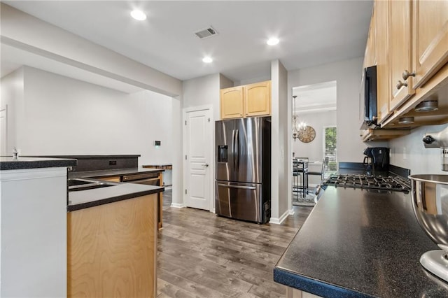 7927 Keepsake Ln, Flowery Branch, GA 30542 - kitchen featuring stainless steel fridge with ice dispenser, light brown cabinetry, dark countertops, dark wood-type flooring, and stove