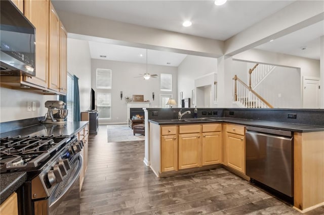 7927 Keepsake Ln, Flowery Branch, GA 30542 - kitchen featuring stainless steel appliances, open floor plan, dark wood-style floors, dark countertops, and recessed lighting