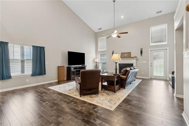 7927 Keepsake Ln, Flowery Branch, GA 30542 - living room featuring high vaulted ceiling, wood finished floors, stairway, a ceiling fan, and a warm lit fireplace