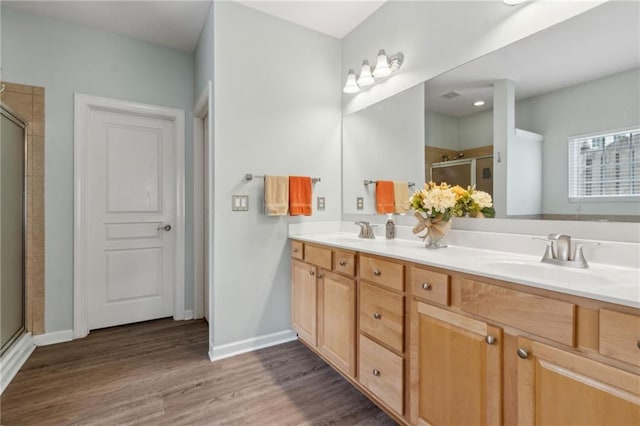 7927 Keepsake Ln, Flowery Branch, GA 30542 - bathroom with a stall shower, double vanity, and wood finished floors