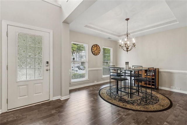 7927 Keepsake Ln, Flowery Branch, GA 30542 - dining area featuring a chandelier, wood finished floors, a tray ceiling, and crown molding
