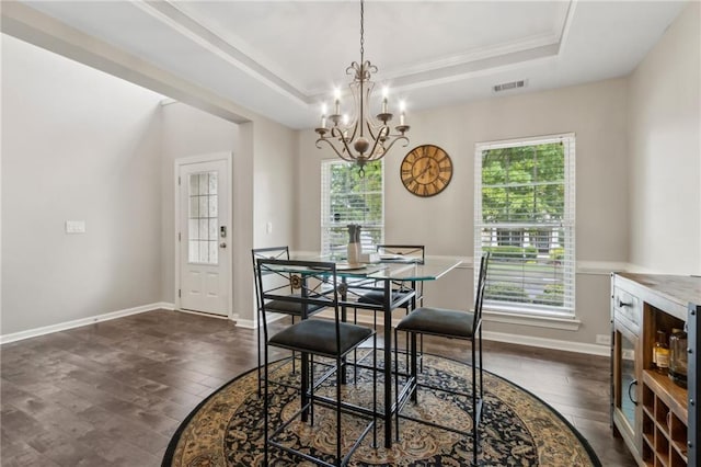 7927 Keepsake Ln, Flowery Branch, GA 30542 - dining area with dark wood-style flooring, a chandelier, a tray ceiling, and crown molding
