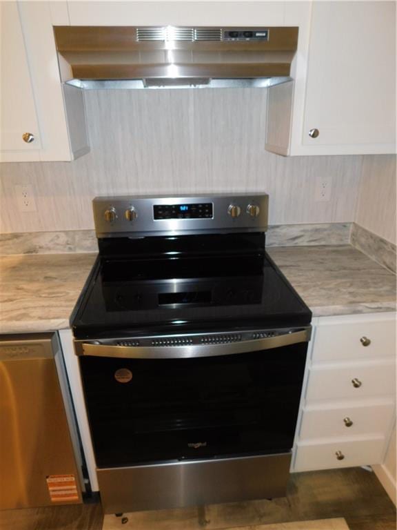 129 Lost Pl, Dahlonega, GA 30533 - kitchen with range with electric stovetop, under cabinet range hood, stainless steel dishwasher, light countertops, and white cabinetry