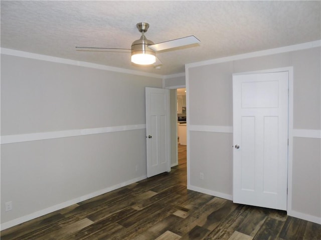 129 Lost Pl, Dahlonega, GA 30533 - unfurnished bedroom featuring dark wood-style flooring, baseboards, ceiling fan, a textured ceiling, and crown molding